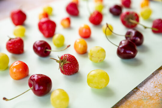 Various fresh berries isolated on pstel background,creative flat lay.Colorful fruit pattern, side view.Creative summer food concept