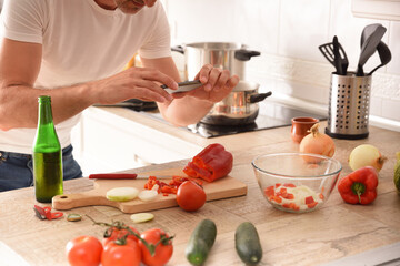 Man recording on mobile the preparation of a dish