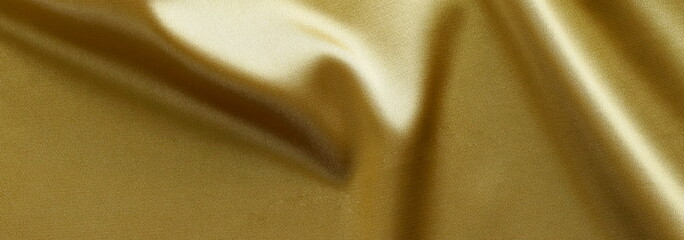 Gold silk fabric texture banner. Beautiful soft crumpled silk wedding, xmas background. copy space
