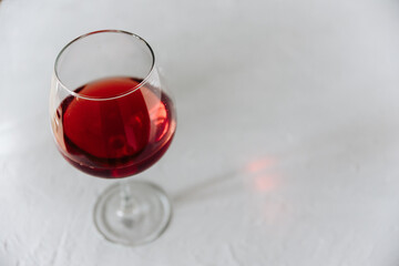 One glass of wine on a gray background