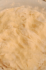 Raw dough mixed in a bowl for making homemade dumplings