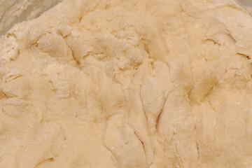 Raw dough mixed in a bowl for making homemade dumplings