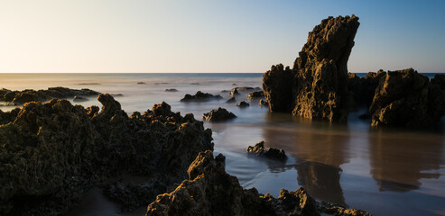 Rocks on the beach with blue horizon