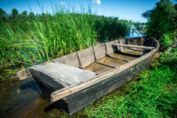 Fototapeta na wymiar Old wooden boat by the river, beautiful scenery