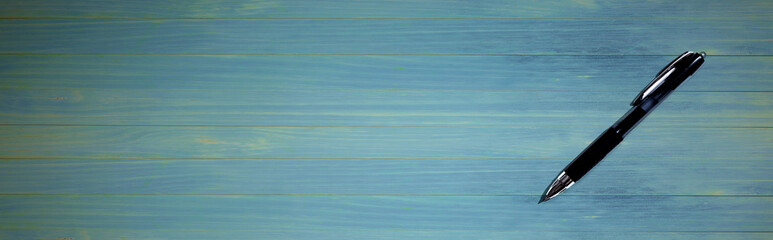 Black pen with shadow from above - flat lay