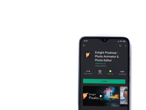 Lod, Israel - July 8, 2020: Enlight Pixaloop app play store page on the display of a black mobile smartphone isolated on white background. Top view flat lay with copy space.