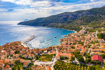 Aerial panoramic view of city Komiza - the one of numerous port towns in Croatia, is a lot of moored sailboats of a regatta