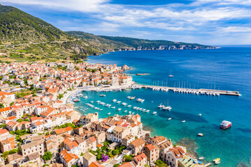 Aerial panoramic view of city Komiza - the one of numerous port towns in Croatia, is a lot of moored sailboats of a regatta