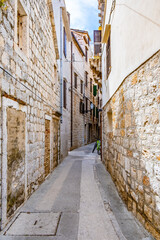 Komiza, Vis, Croatia, streets of Komiza town, Old stone houses in a charming narrow alley, typical Mediterranean architecture.