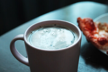 Cup of the coffee and slice of pizza