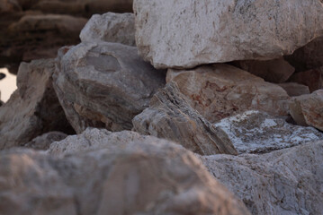 A close up of the surface of the grey stone. Close-up of a rocky cliff. Stones. Background