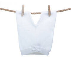 White baby pants on rope on white background isolation