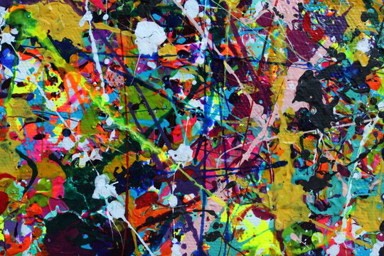 Acrylic paint splatters cover the canvas in this abstract background.