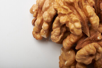Walnut kernels on a wooden background.