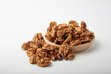Walnut kernels on a wooden background.