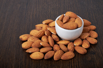 nuts almonds in a Cup on a wooden background