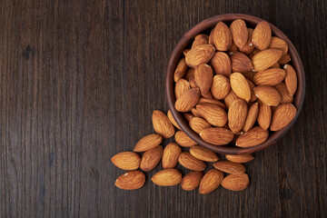 nuts almonds in a Cup on a wooden background