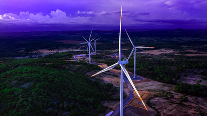 Wind turbines or wind power generators at sunset in the evening. Alternative green ecological power energy generation © Creative Cat Studio