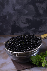 Washed ripe black currant in the sieve
