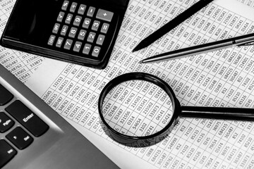 business office desk closeup - financial reports, analysis and accounting, set of documents, tables and graphs, various items for bookkeeping, calculator