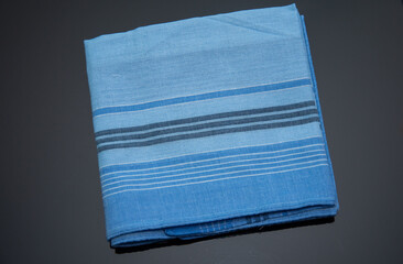 blue handkerchief with lines on the black background