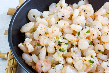 Roasted Shrimp with Garlic, Pepper and Lemon in black pan.