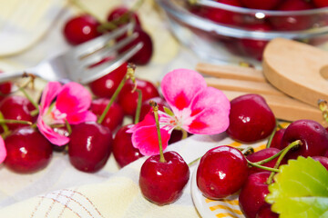 plate of red cherries on the checkered tablecloth