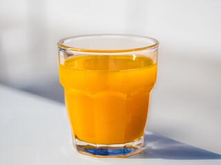 Glass of orange juice against white background