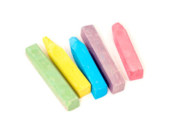 colorful children's crayons on a white background macro photo