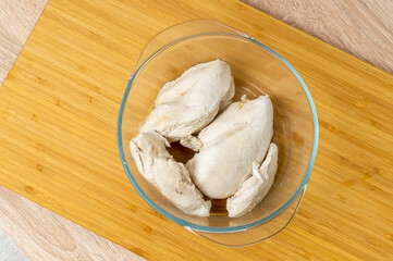 boiled chicken breast without skin in a glass plate, protein for athletes