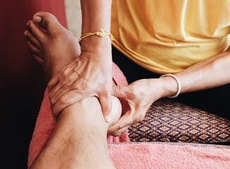 Close up of the traditional Thai foot massage, Foot pain treatment