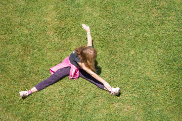 woman with medical mask doing gymnastics on the grass, new normal concept