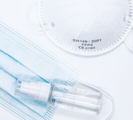 Close up of virus protective masks and hand sanitizer on white
