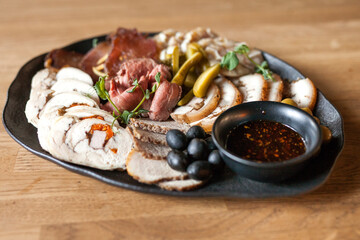 Meat plate. Cutting cold cuts. Grilled meat dinner. A dish of various types of meat and sausages