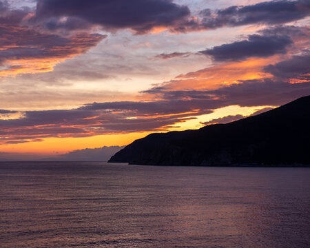 Sunset Over The Italian Coast With Mountains On The Horizon