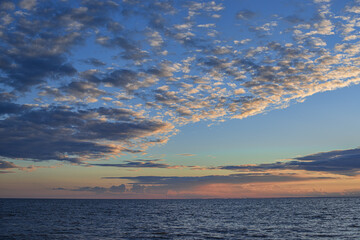 picturesque view of endless seascape with sunset reflecting on mirror water surface