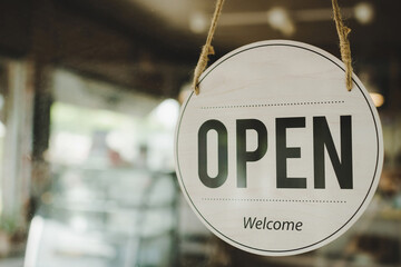 Open. coffee cafe shop text on vintage sign board hanging on glass door in modern cafe coffee shop, cafe restaurant, retail store, small business owner, takeaway food, food and drink concept