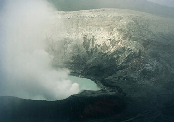 Crater Lake with smoke in Poas Volcano National Park, Costa Rica