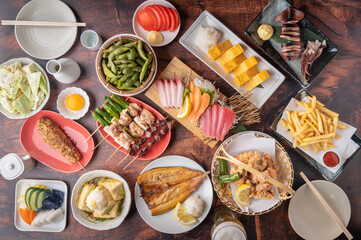 Fototapeta na wymiar traditional japanese izakaya style foods on wooden table