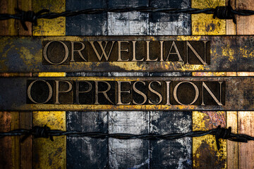 Orwellian Oppression text formed with real authentic typeset letters on vintage textured silver grunge copper and gold background