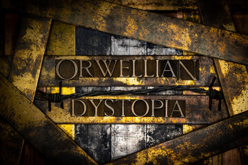 Orwellian Dystopia text formed with real authentic typeset letters on vintage textured silver grunge copper and gold background