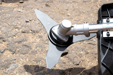 Lawn mower on a background of asphalt. Assembling a lawn mower close up.