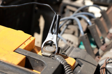 Connected compressor to car battery. Cigarette lighter on battery terminals. Car maintenance.