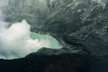 Fototapeta na wymiar Crater Lake with smoke in Poas Volcano National Park