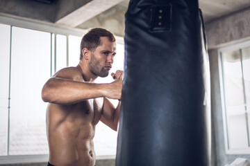 Portrait of young Caucasian muscular strong man boxing training exercise in gym fitness. Boxer workout punching bag fist. fighting sport. Healthy wellness lifestyle  concept