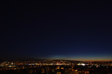 Panorama of Zurich at night with twilight in the sky as seen from Triemli
