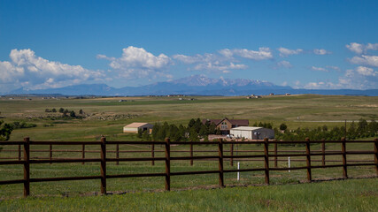 Ranch in Colorado with fence in foreground