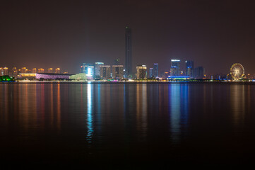 Fototapeta na wymiar Suzhou city viewed from the lake with colorful lights reflecting in the water.