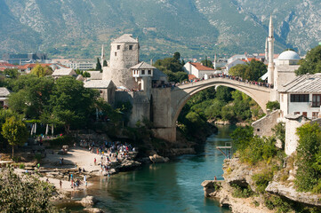 Fototapeta na wymiar Mostar bridge with mountains in background, Bosnia and Herzegovina
