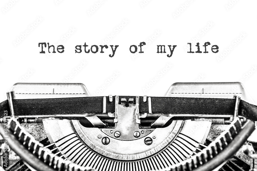 Fototapete the story of my life is typed on a blank sheet of paper with an old typewriter. close-up